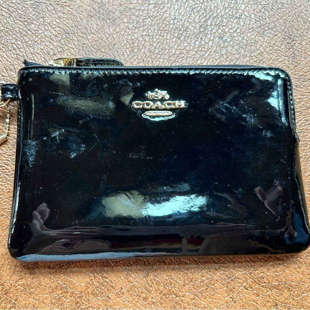 Coach patent leather, black wristlet, new without tags, never been used.